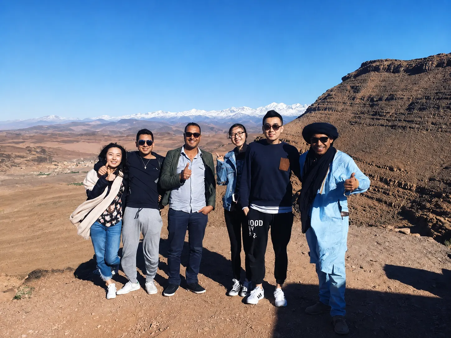 Group of travellers with guide at a mountain viewpoint in the Middle Atlas