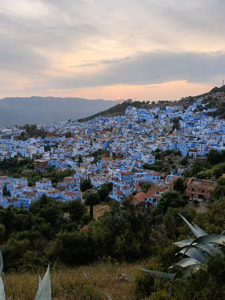 Chefchaouen blue city cascading down the hillside at sunset
