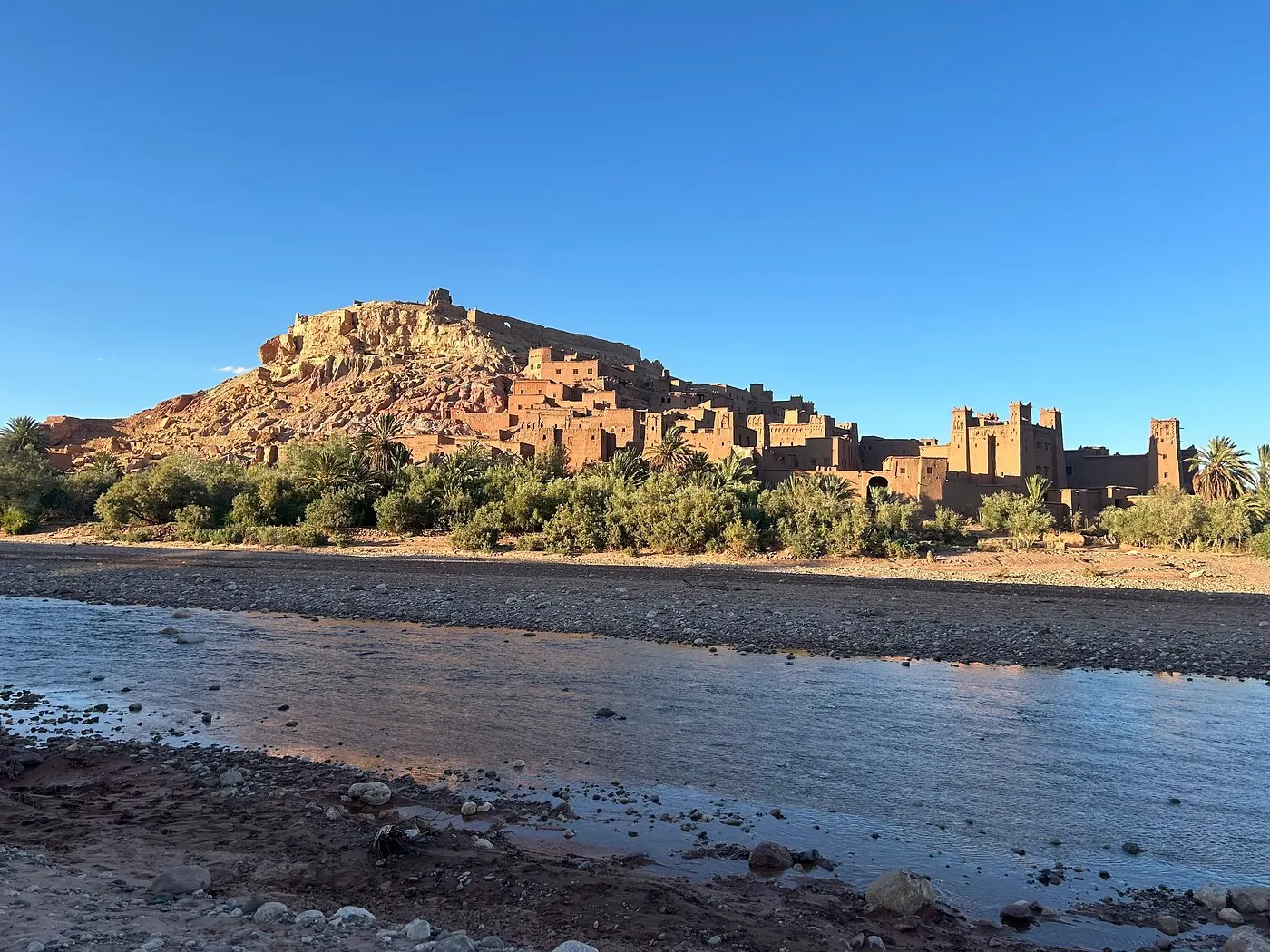 The UNESCO Kasbah of Ait Ben Haddou rising above the dry riverbed at the edge of the desert