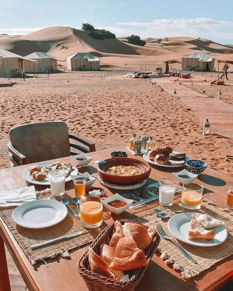 A generous breakfast spread with bread, honey, and fresh fruit