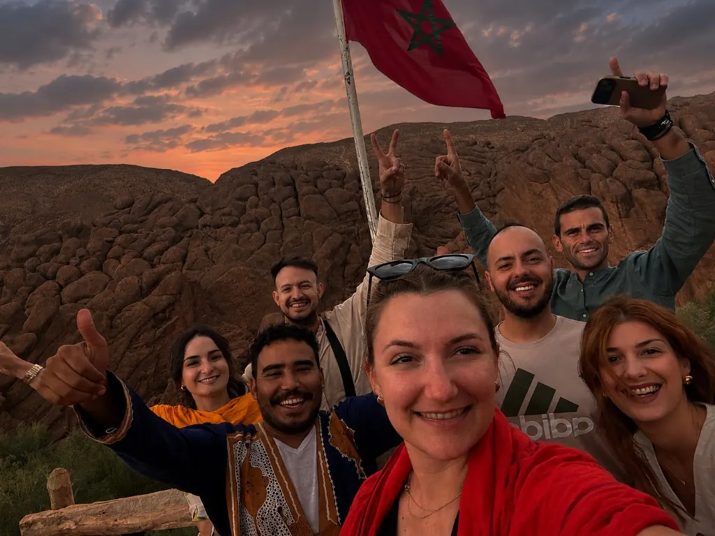 Group of travellers with Ahmed at sunset in the Dades Valley, Morocco